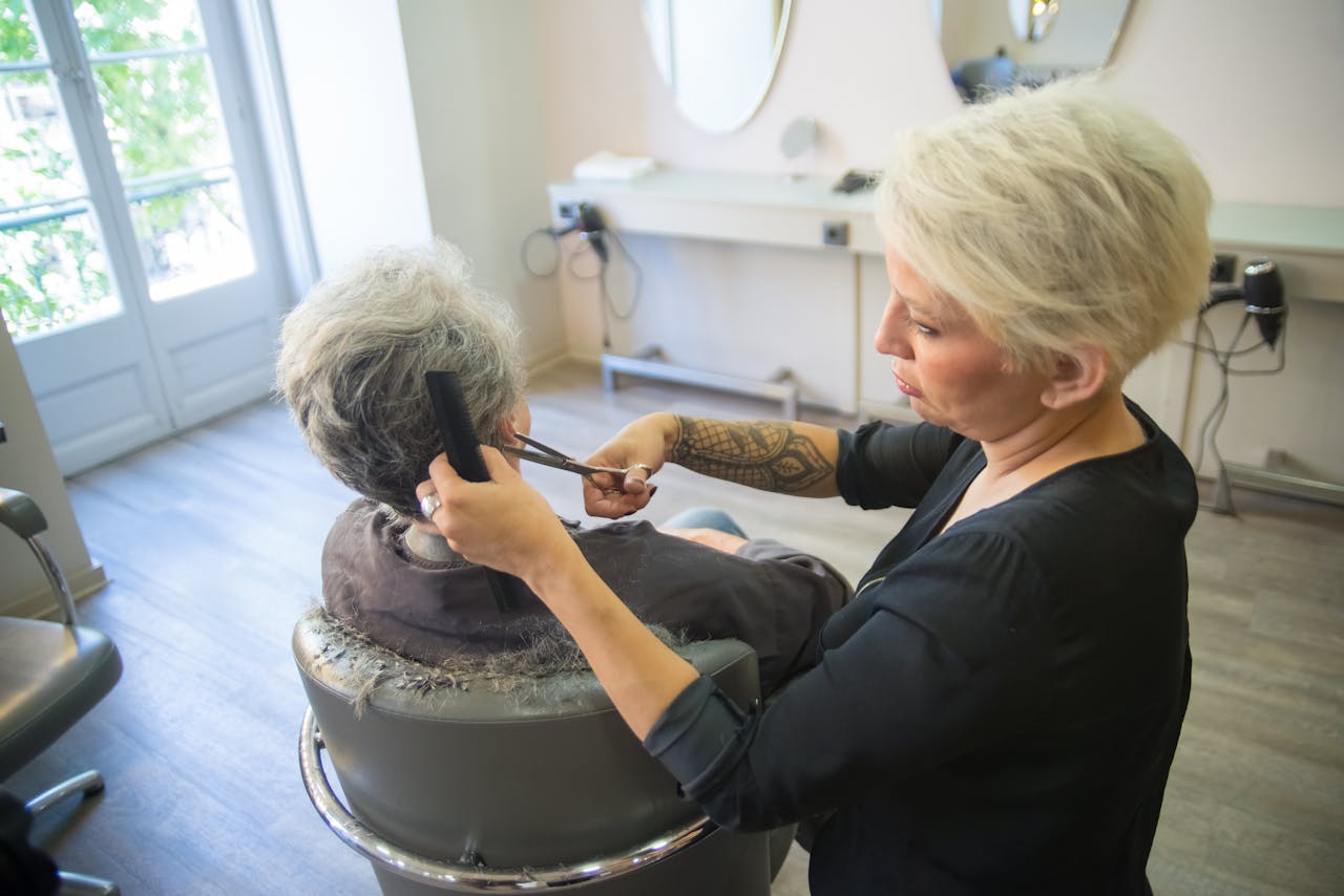 digital A hairdresser expertly cuts a client's hair in a modern salon setting, showcasing skill and style.